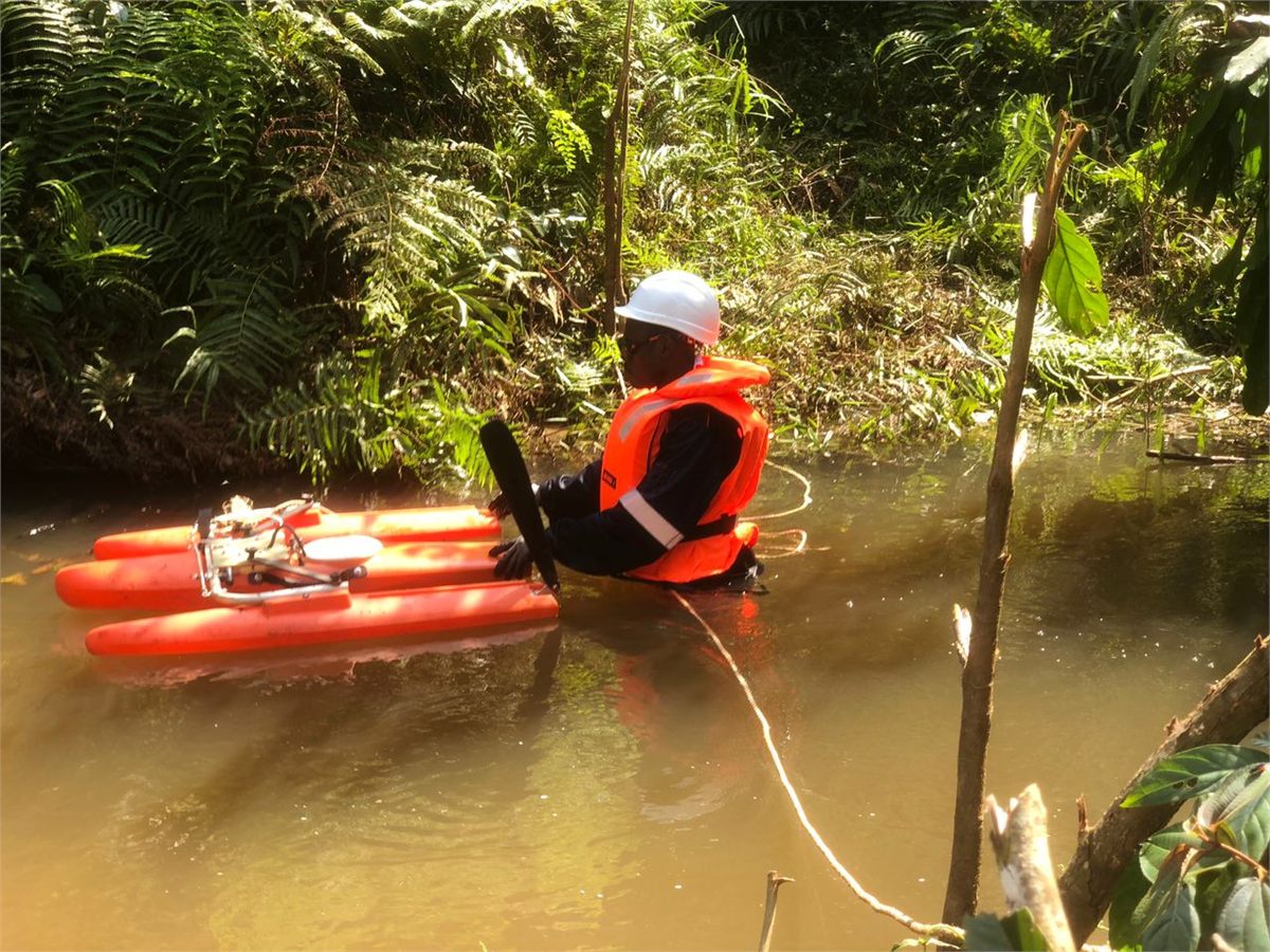 Technicien de Somme Up Services réalisant un jaugeage par ADCP sur un cours d'eau en forêt gabonaise